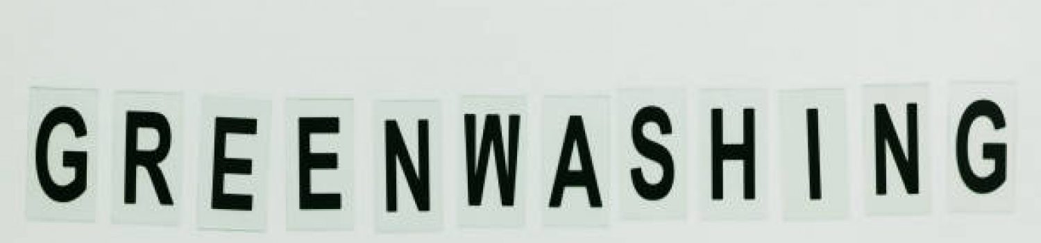 Text GREENWASHING on green background. Green PR, green marketing and misleading information about company products being eco-friendly concept